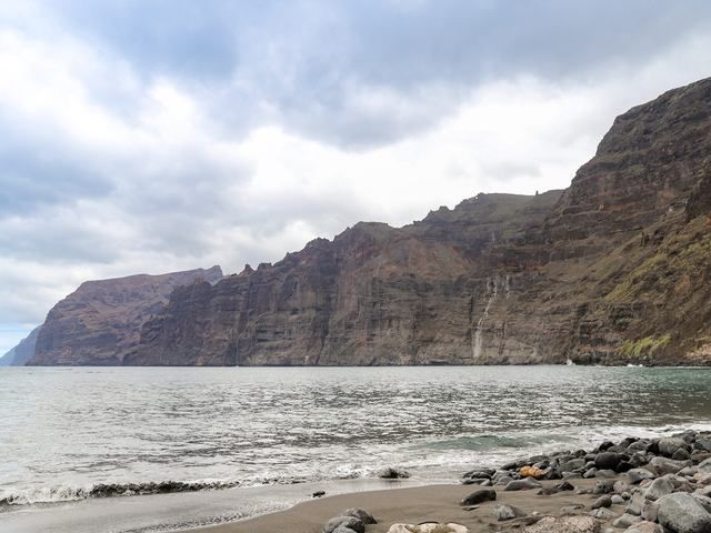 The sheer Los Gigantes sea cliffs above a black-sand beach