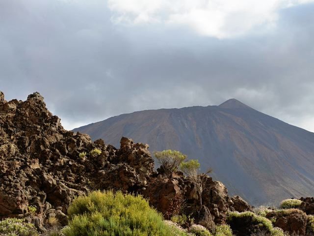 A hiking trail over lava fields with the Teide volcano behind
